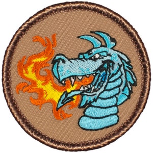 May include: A blue dragon with orange flames coming out of its mouth. The dragon is embroidered on a brown background with a brown stitched border.
