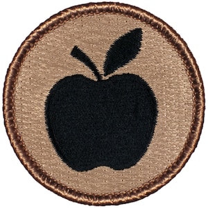 May include: A brown embroidered patch with a black apple silhouette.