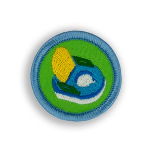 May include: A blue and green embroidered patch with a yellow lemon and a blue wave design.