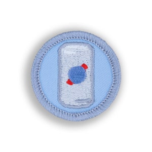 May include: Embroidered patch featuring a light blue background with a white soda can design. A blue sphere with red accents is in the center of the can. The patch has a light blue border.