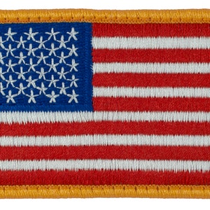 May include: A small embroidered American flag patch with a gold border. The flag is red, white, and blue with 13 stripes and 50 stars.
