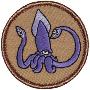 May include: Purple embroidered squid patch with a brown border. The squid has one large eye and tentacles.