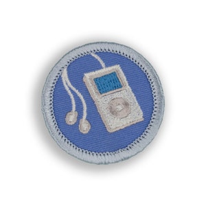 May include: A blue and white embroidered patch with a white MP3 player and headphones. The MP3 player has a blue screen and a white button.