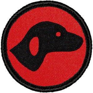 May include: A black embroidered dog silhouette on a red circle with a black border. The dog is facing right and has a simple design.