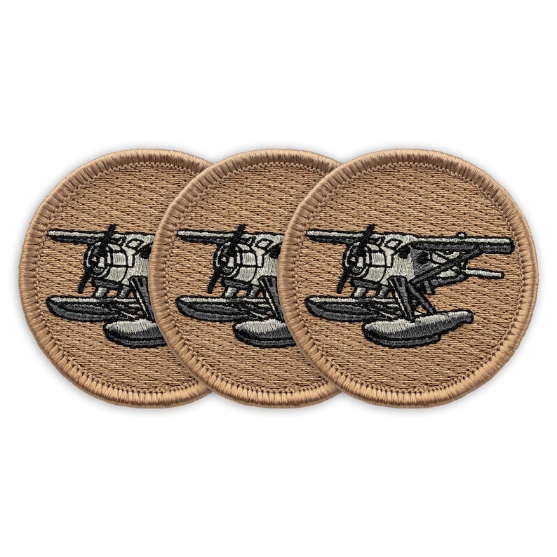 May include: Three brown embroidered patches with a white and black seaplane design. The seaplane has two floats.