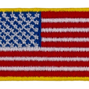 May include: Embroidered patch featuring the American flag. The design includes a blue field with white stars and red and white stripes. The patch has a yellow border and is rectangular in shape.