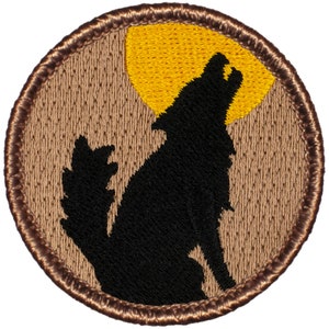 May include: A brown embroidered patch with a black silhouette of a wolf howling at a yellow moon.