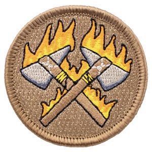 May include: A tan embroidered patch with two crossed axes with flames on the handles. The axes are gray and the flames are orange and yellow.