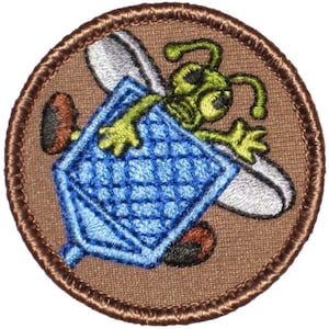 May include: A brown embroidered patch with a green cartoon bee holding a blue honeycomb. The bee has large eyes and a white wing.