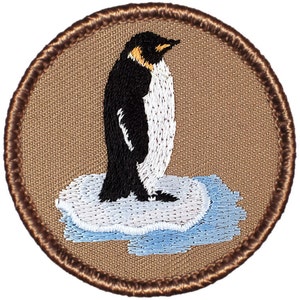 May include: A brown embroidered patch with a white outline featuring a black and white penguin standing on a blue and white ice floe.