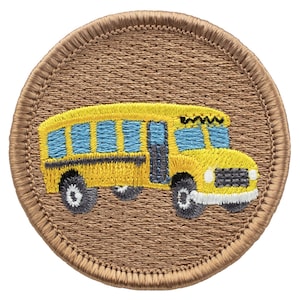 May include: A brown embroidered patch with a yellow school bus with blue windows. The bus has a black stripe and black wheels.