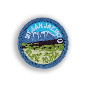 May include: A blue embroidered patch with the text "Mt. San Jacinto State Park" and a depiction of a mountain range.