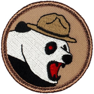 May include: A brown embroidered patch with a white panda bear wearing a brown ranger hat. The panda has black eyes with red pupils and an open mouth with a red tongue.