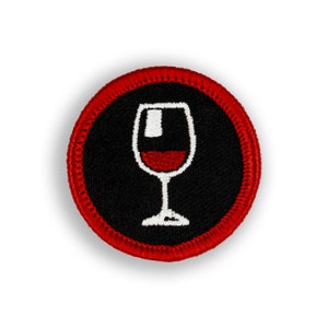 May include: A red and black embroidered patch with a white wine glass filled with red wine.