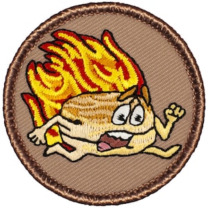 May include: A round, brown embroidered patch with a cartoon image of a brown, striped, running figure with a yellow and red flame on its head. The figure has a surprised expression with large eyes and an open mouth.