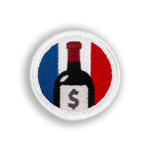 May include: A white, red, and blue embroidered patch with a wine bottle in the center. The bottle has a dollar sign on the label.