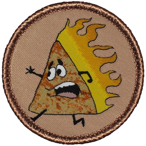 May include: A brown and tan embroidered patch with a cartoon image of a triangle shaped pizza slice with a yellow flame on top. The pizza slice has a face with big eyes and a mouth open in a scream. The pizza slice has two arms and two legs.