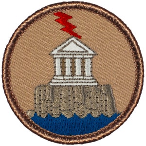 May include: A brown embroidered patch with a white building with a red lightning bolt on top. The building is on a brown rock formation with blue water below.
