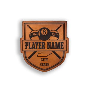 May include: Brown leather patch with a pool cue design, three billiard balls, and the text "PLAYER NAME", "CITY", and "STATE".