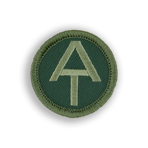 May include: A green embroidered patch with a white outline of the Appalachian Trail logo, a triangle with a line across the middle and a vertical line at the bottom.