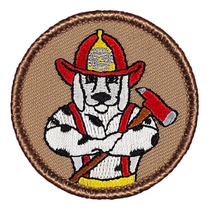 May include: A brown embroidered patch with a cartoon Dalmatian dog wearing a red firefighter helmet and holding an axe. The dog is wearing a red and yellow firefighter uniform.