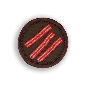 May include: A brown embroidered patch with three red and white stripes, resembling bacon.