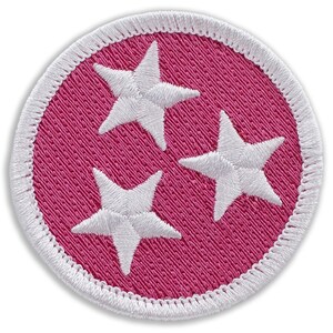 May include: A pink and white embroidered patch with three white stars on a pink background. The patch has a white border.