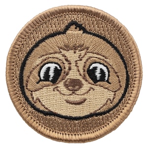 May include: Embroidered patch featuring a cartoon sloth with big eyes and a smile. The patch is brown and has a black outline.
