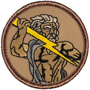 May include: Embroidered patch featuring a brown and yellow image of Zeus, the Greek god of thunder, holding a lightning bolt. The patch is circular and has a brown border.