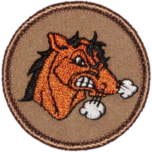 May include: Embroidered patch with a brown background and a cartoon image of an angry, orange horse with black hair and white smoke coming out of its nostrils.