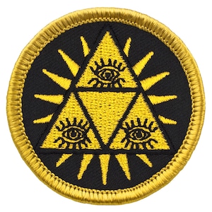 May include: A yellow embroidered patch with a black background. The patch features a yellow triangle with three eyes inside. The triangle is surrounded by a yellow sunburst.