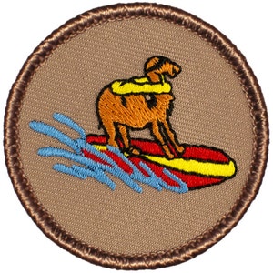 May include: A brown embroidered patch with a cartoon dog wearing a yellow life preserver and riding a red surfboard with yellow trim. The dog is riding a wave with blue water.