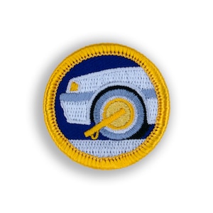 May include: A blue and yellow embroidered patch with a white car with a yellow tire and a yellow key.