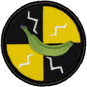 May include: A round black and yellow patch with a green banana and white lightning bolts. The patch has a black border.