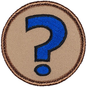 May include: A brown embroidered patch with a blue question mark in the center.