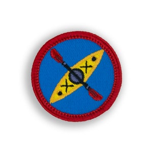 May include: A red and blue embroidered patch with a yellow kayak and two red paddles. The kayak has black markings.