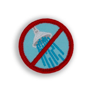 May include: A red and white embroidered patch with a shower head and water droplets. A red line is drawn across the shower head, indicating a no shower symbol.