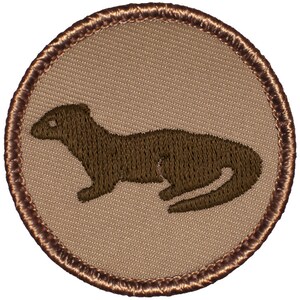 May include: A circular patch featuring a brown weasel embroidered on a tan background. The weasel is depicted in profile, with detailed stitching. The patch has a brown stitched border, creating a classic, outdoorsy aesthetic.