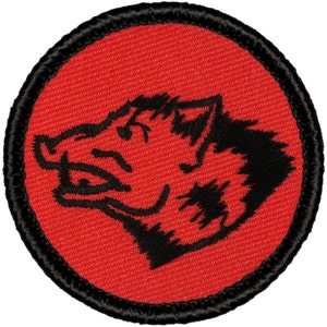May include: Red embroidered patch with a black outline. The patch features a black silhouette of a wild boar's head.