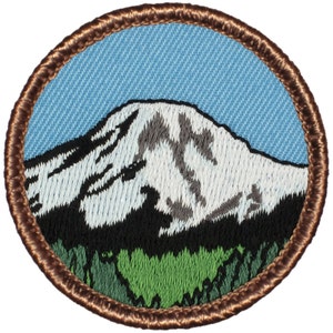 May include: A brown embroidered patch with a white mountain peak and green trees against a blue sky.