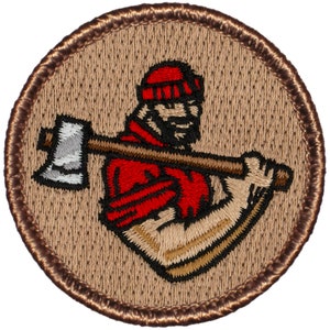 May include: A brown embroidered patch with a brown border. The patch features a cartoon lumberjack wearing a red shirt and a red hat, holding an axe.