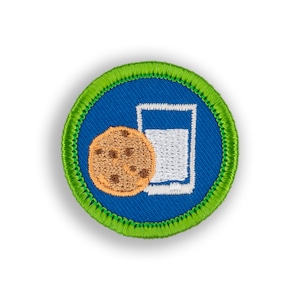 May include: A blue and green embroidered patch with a chocolate chip cookie and a glass of milk. The patch is a circle with a green border and a blue center.