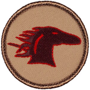 May include: A brown embroidered patch with a red outline of a horse's head. The patch is circular and has a brown border.