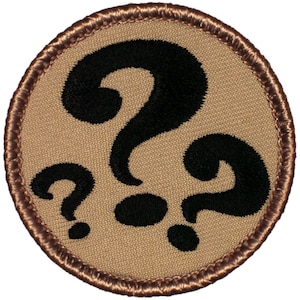 May include: A brown embroidered patch with a black question mark design. The question mark is repeated three times.