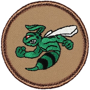 May include: A brown embroidered patch with a green wasp with black stripes and red eyes. The wasp is flying and has its fists clenched.