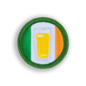 May include: Embroidered patch featuring the Irish flag with a pint of beer in the center. The patch has a green border and the beer is yellow. The flag colors are green, white, and orange.