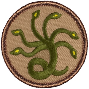 May include: A brown embroidered patch with a green five-headed snake design. The snake has yellow eyes and is coiled in a circular pattern.