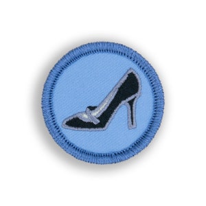 May include: A blue embroidered patch with a black high-heeled shoe in the center.