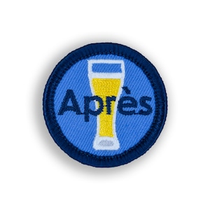 May include: A blue and navy blue embroidered patch with a glass of beer and the word "Aprés" in white.