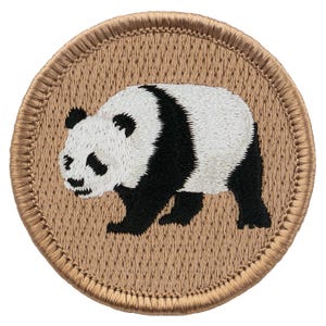 May include: Embroidered patch featuring a black and white panda bear on a brown background. The patch has a stitched border.